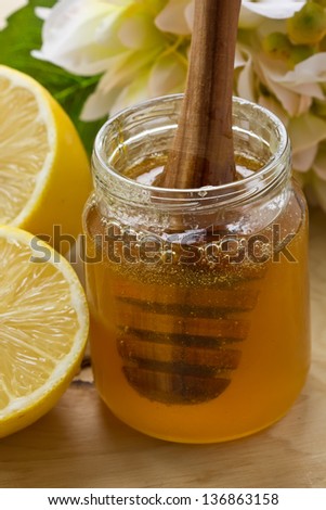 Fresh honey in glass bank . Selective focus.