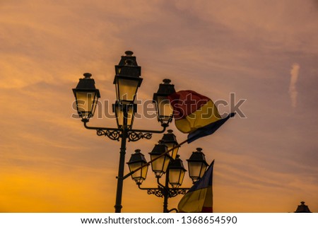 Romanian flag on lighting poles, in Timisoara Royalty-Free Stock Photo #1368654590