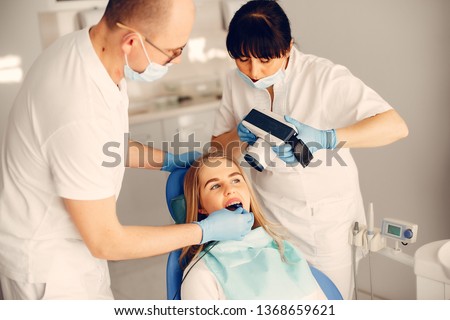Beautiful lady in the dentist's office. Woman in a uniform