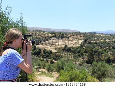 Woman photographer Nature photographer shooting in the mountains. Travel Concept.