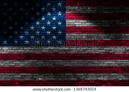 USA flag on brick wall at night