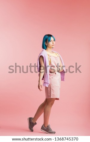 lovely girl with cool appearance going for a walk. full length photo. isolated pink background.