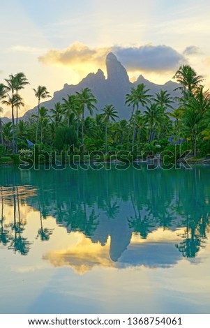 View of the Mont Otemanu mountain reflecting in water at sunset in Bora Bora, French Polynesia, South Pacific Royalty-Free Stock Photo #1368754061