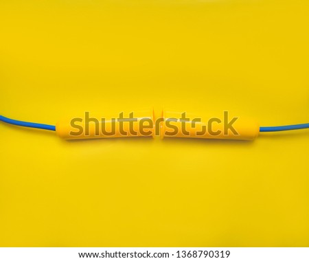 Sports jumping rope on yellow background. Top view.