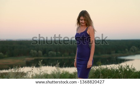 photo of a beautiful girl on the 
landscape background 