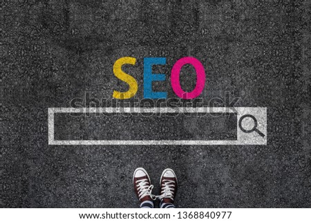 man in shoes standing on asphalt next to SEO search engine