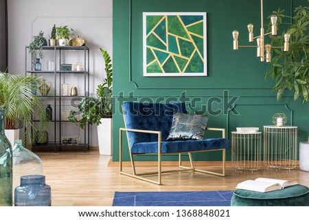 Stylish living room interior idea with green, blue and gold colors Royalty-Free Stock Photo #1368848021