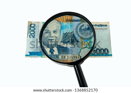two thousand Laos kip bill and a magnifying glass isolated on a white background, obverse front side