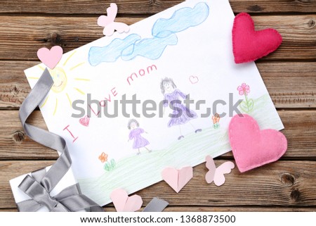Greeting card for Mothers Day with gift box and hearts on wooden table