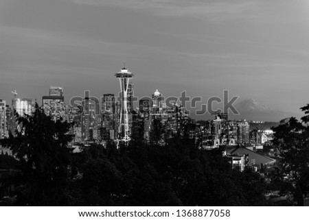 Black and white image of the skyline of the city of Seattle with the Space Needle, other emblematic buildings and the profile of Mount Rainier in the background,  Washington, USA.