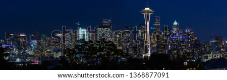 Panoramic night view of the Seattle skyline with the Space Needle and other iconic buildings in the background, Washington, USA.
