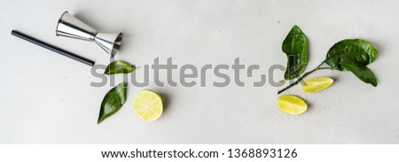 Accessories for cocktails, lime, greens on soft background. Long wide banner with copy space. 