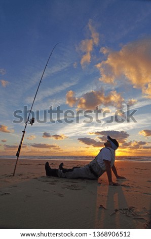 Surf fisherman waiting for fish, night fishing
