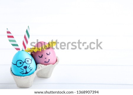 Cute easter eggs on white wooden table