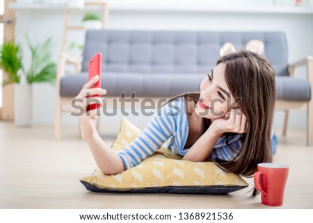 beautiful woman taking selfie in the living room