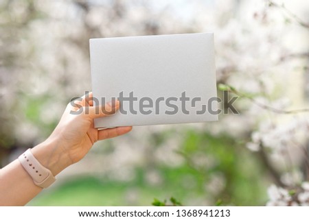 Wedding invitation cards, craft envelopes, pink and white flower and green leaves on white background