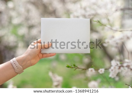 Wedding invitation cards, craft envelopes, pink and white flower and green leaves on white background