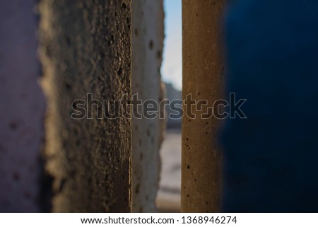 abstract photo of a crack between two concrete slabs in the fence