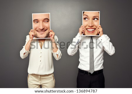 woman and man holding images with big smiley faces