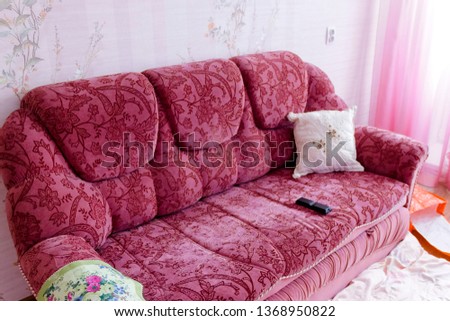 pictured in the photo pink sofa that stands in the room