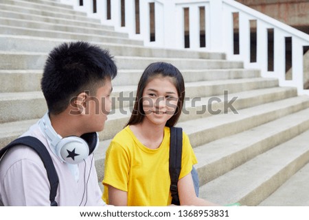 Two students guy and girl studying stairs in park of happy teen high school students outdoors