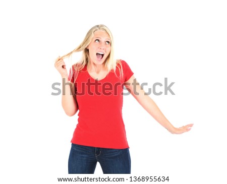 Excited young blonde woman looking up against a white background