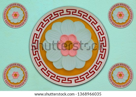 Three-color flower carving mortar on orange background And a light green background adorned with sacred places in Chinese temples, Thailand. Close to choosing focus that is shallow depth