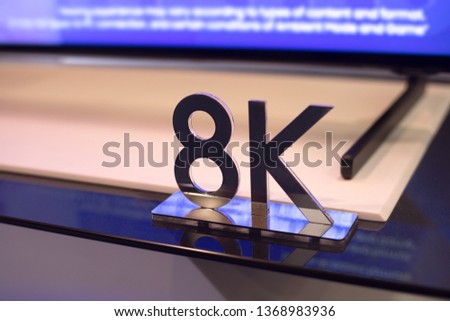 8K HD Sign and TV on background, selective focus