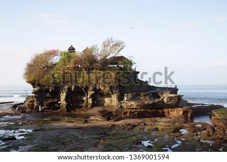 traditional Bali temple build on a small island in the sea and only accessible at low tide