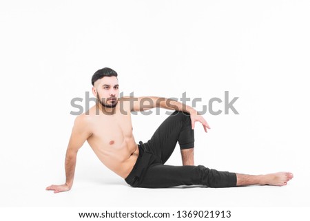 Handsome model man posing to the camera wearing at black pants!