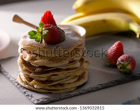 American pancakes with chocolate strawberries and banana