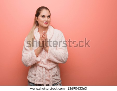 Young russian woman wearing pajama devising a plan
