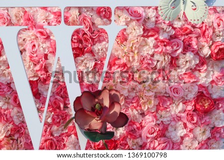 Font type W with background image of pink roses summer blooming delicate.