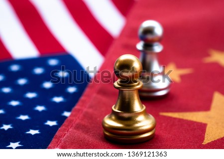 Chess game, two pawn face to face on China and US national flags. Trade war concept. Conflict between two big countries, USA and China concept. Copy space. Royalty-Free Stock Photo #1369121363
