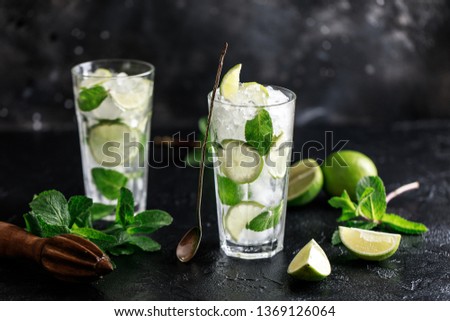 Mojito cocktail with lime, lemon and mint in a glass. Freshness cocktail 