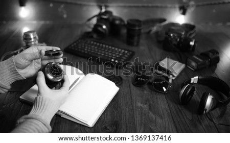 The photographer's desk, digital camera accessories and lenses
