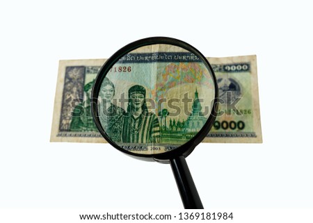 one thousand Laos kip bill and a magnifying glass isolated on a white background, obverse front side
