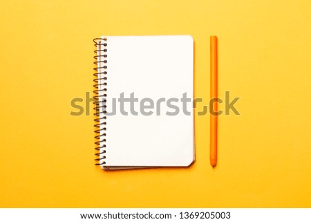 blank notebook on yellow background