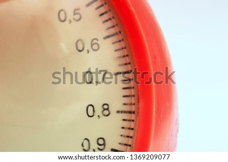 Measured divisions on red scales close up