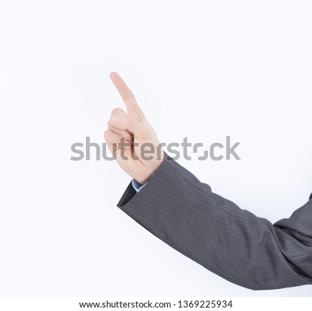 hand of a businessman pointing at a dot on a blank screen.