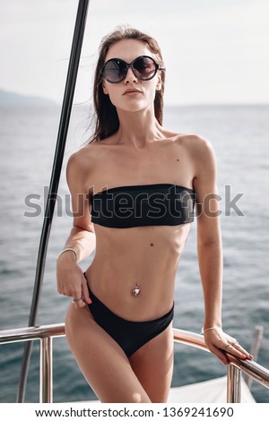 Beautiful girl with perfect body posing background the sea. Woman on the yacht. Traveling female. 