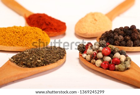 Group of indian spices and herbs difference ware in wooden spoons on white background and copy space for design foods, vegetable, spices, herbs, healthy lifestyle or other your content.