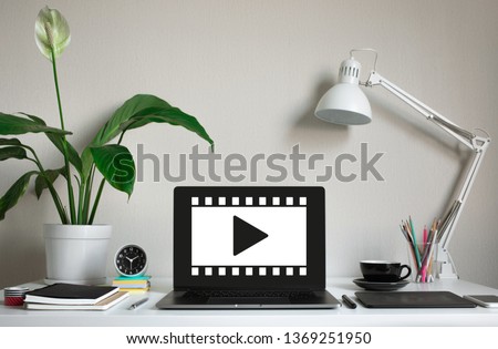 Video movie content or online marketing concepts with film sign on computer laptop on worktable.