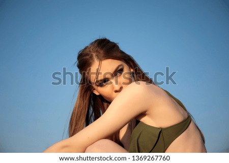 Fashion model portrait on the beach at sunset. Pretty girl in swimsuit. Beautiful bohemian styled woman.