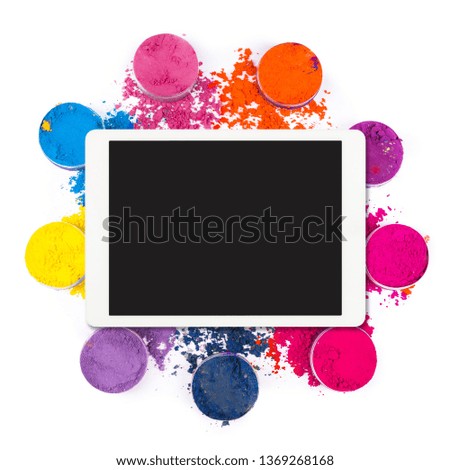 Flat lay of white touchpad with blank touchscreen with colorful powder isolated on white background. Tablet computer with colors. Top view