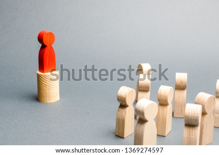 Red man stands on the podium and appeals to the crowd of people. Agitation, appeal and appeal to the crowd. Leader and leadership qualities, political movement, mass management. To attract attention. Royalty-Free Stock Photo #1369274597