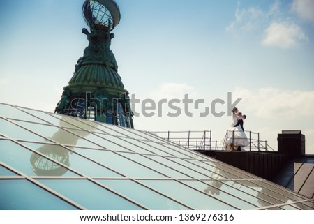 Bride and Groom on Wedding Day in city on roof in St. Petersburg.
