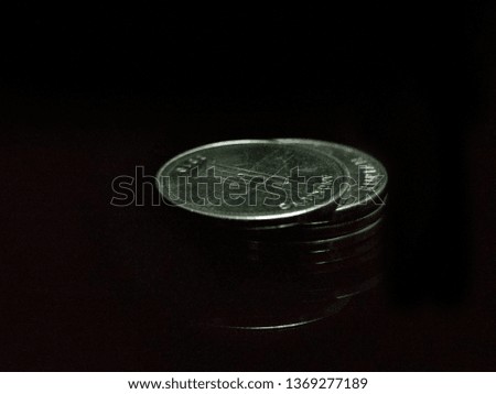 stack of coins isolated on black background