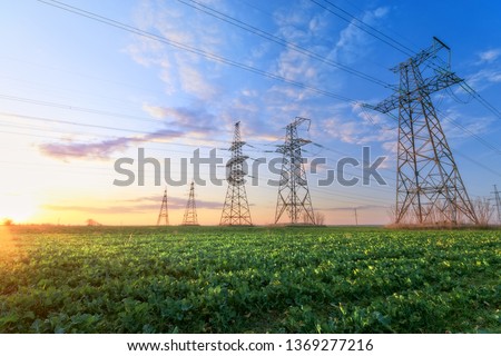 power line summer landscape / passing overhead electricity wire of the support carrying the light and the heat in the house Royalty-Free Stock Photo #1369277216