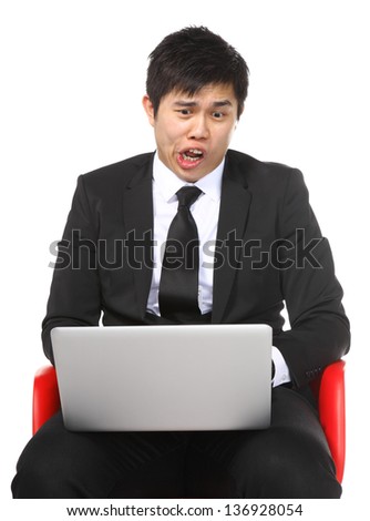Asian businessman shocked surprise by laptop computer